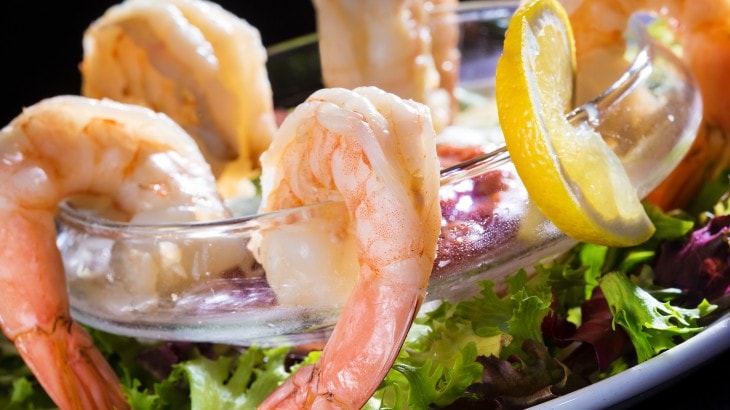 Chilled shrimp cocktail with lemon garnish
