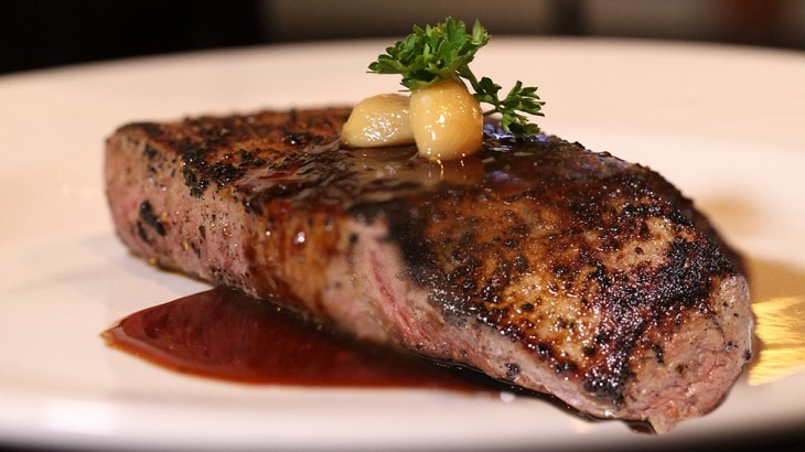 Seared steak with capers and parsley
