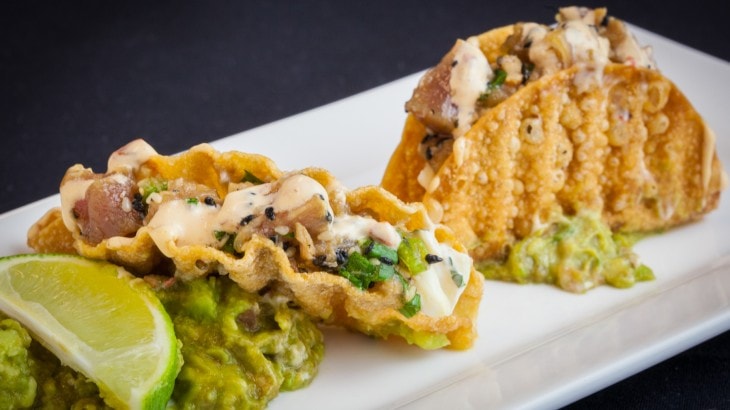 Fried fish tacos with guacamole and lime